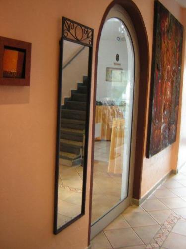 a mirror on the side of a room with a staircase at City Hotel Mercator in Frankfurt/Main