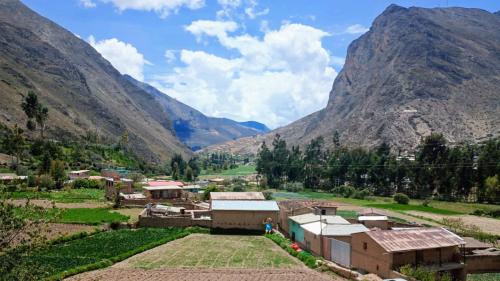 a village in a valley with mountains in the background at La Finca Tarma in Tarma