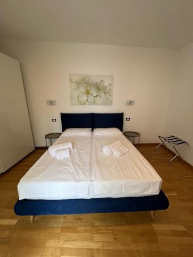 a bedroom with a large bed with two towels on it at Haus and Beach in Brenzone sul Garda