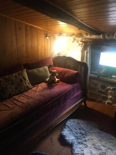 a teddy bear sitting on a couch in a room at Gites de Gobertier in Saint-Alban-dʼAy