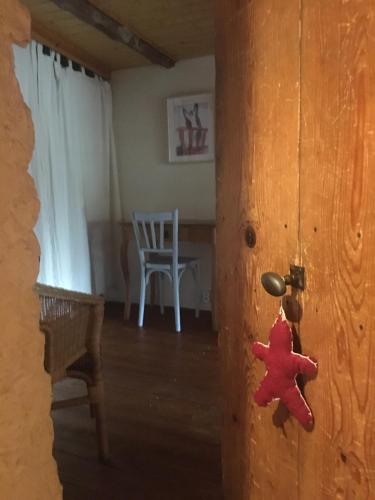 a door with a red teddy bear hanging on it at Gites de Gobertier in Saint-Alban-dʼAy