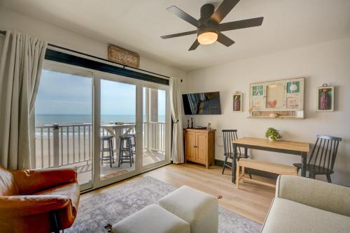 a living room with a ceiling fan and a view of the ocean at Topsail Dunes 1213 - BLDG 1 in North Topsail Beach