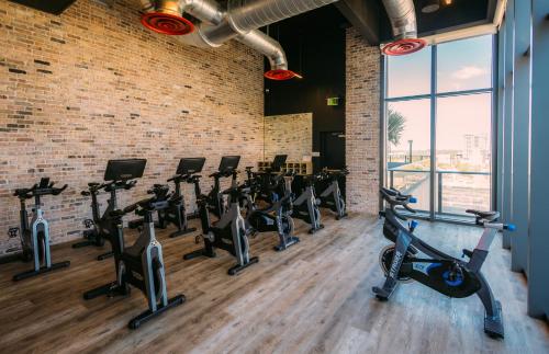 a gym with a row of cardio bikes and treadmills at Flow Fort Lauderdale Hotel in Fort Lauderdale
