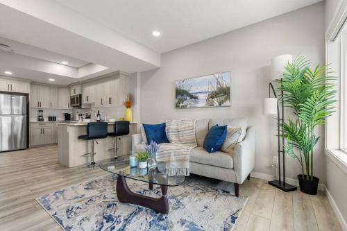 a living room with a couch and a table at Brand New Luxury Walk-out Suite - Calgary in Calgary
