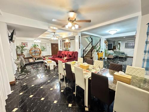 a living room with a red couch and a table at Comfy Boutique House in Chiang Mai