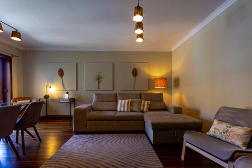 a living room with a couch and a table at 480 Liberdade Apartamento in Labruge