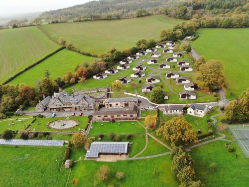 an aerial view of a large estate with houses and trees at Harcombe House Bungalow 1 in Newton Abbot