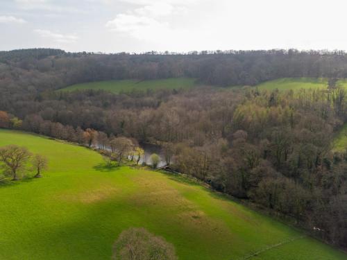 an aerial view of a green field and trees at Harcombe House Bungalow 1 in Newton Abbot