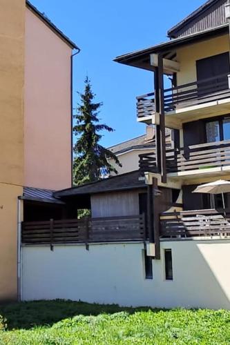 une grande maison avec une clôture et un arbre dans l'établissement l'été en montagne 6 places avec accès piscine, à Ax-les-Thermes