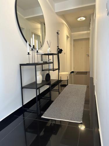 a living room with a mirror and a black floor at Sky hill residence Mostar in Mostar