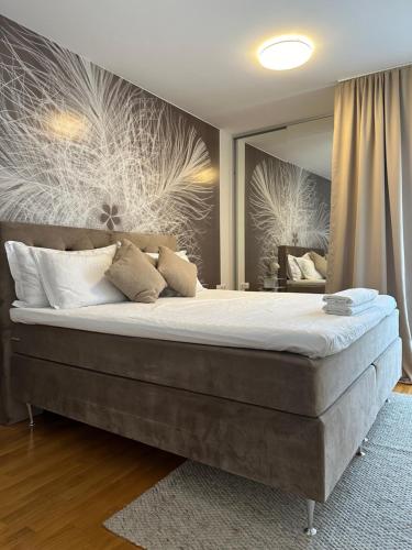 a bedroom with a large bed with a large mirror at Sky hill residence Mostar in Mostar