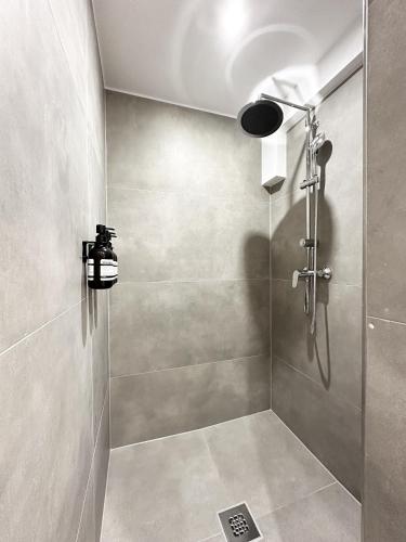 a shower with a glass door in a bathroom at Mike's Four in Düsseldorf
