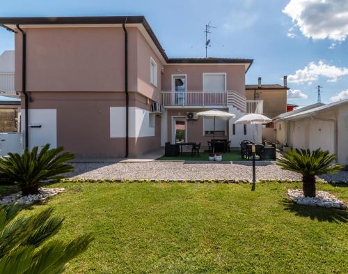 a house with a patio and a yard at La Casara appartamento Eligia in Scardovari