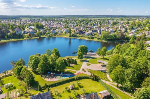 an aerial view of a lake in a city at Molėtai Hotel in Molėtai