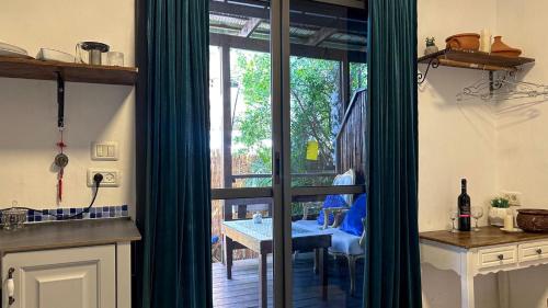 a kitchen with a sliding glass door to a patio at Ahuzat Shaul Seaside in H̱adera