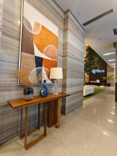 a hallway with a table with a lamp on it at 38 Park Avenue right in the heart of IT Park Cebu, 55 inches TV, wifi in Tabok