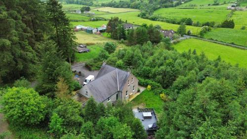 an aerial view of a house in a field at Mourne Mountain Bliss, Rostrevor 4BR Cottage with Patio & BBQ ideal for a relaxing getaway in Rostrevor