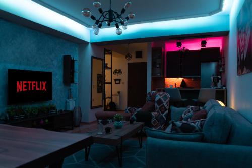 a living room with a person laying on a couch at - All-Around Skopje Apartments - Premium Hospitality - in Skopje