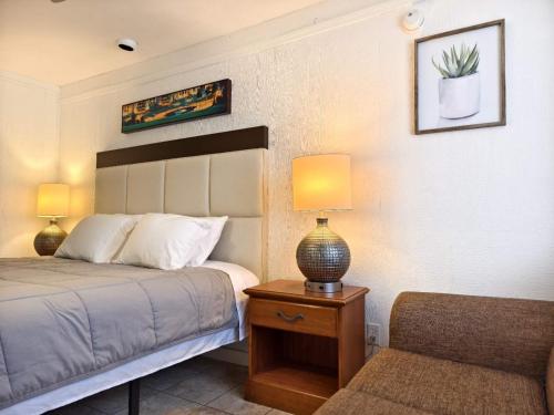 a bedroom with a bed and a table with a lamp at Lake Hudson Inn in Spavinaw