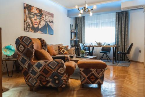 a living room with a couch and chairs at - All-Around Skopje Apartments - Premium Hospitality - in Skopje