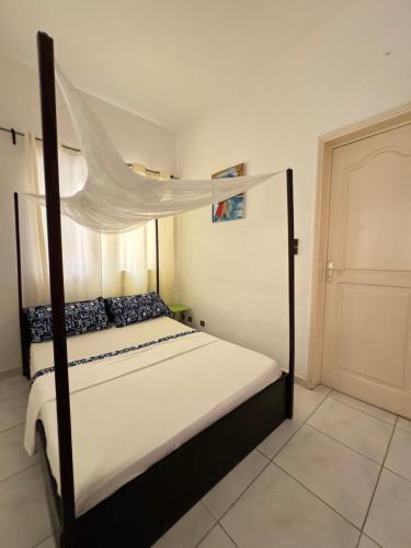 Postel nebo postele na pokoji v ubytování Guesthouse Cocotiers Cotonou
