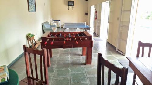 a living room with a foosball table and chairs at Casita Oliveira in Serra Negra