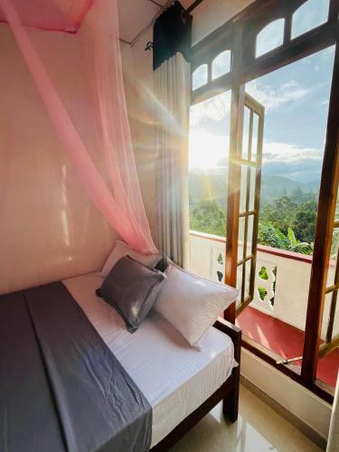 a bed in a room with a large window at O2 Bandarawela in Bandarawela