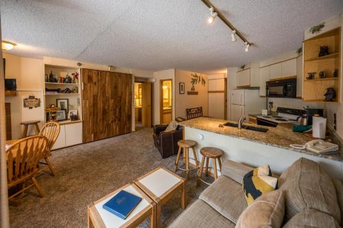 a living room and kitchen with a couch and a table at Iron Horse Building C Unit 1023 in Winter Park