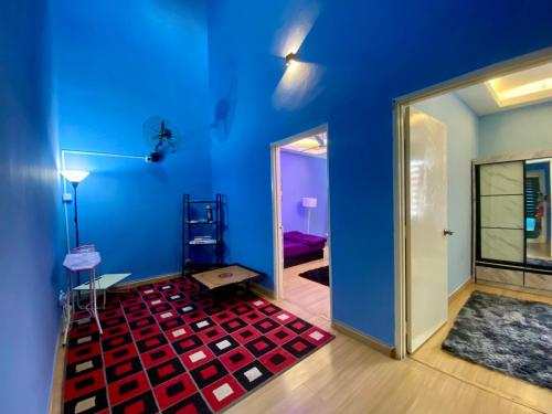 a room with a blue wall and a red carpet at Ilham Restu Homestay Private Pool MSLIM ONLY in Port Dickson
