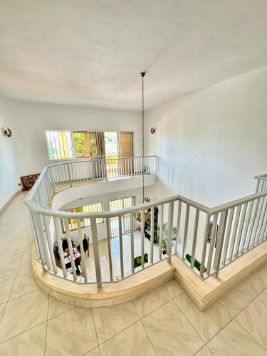 a large room with a staircase with wine bottles at Guesthouse Cocotiers Cotonou in Cotonou