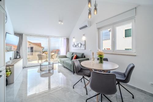 a living room with a table and a couch at Apartmani Indigo in Supetar