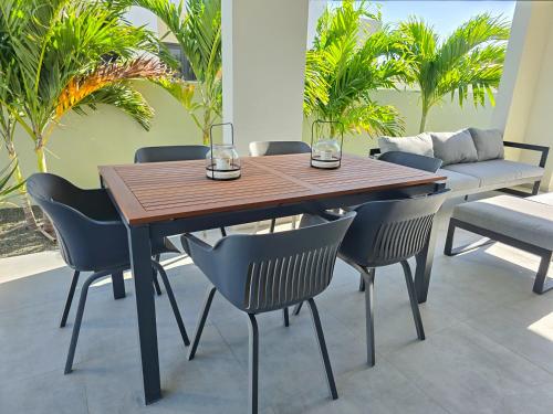 a dining room table with chairs and a couch at La Cesarina in Willemstad