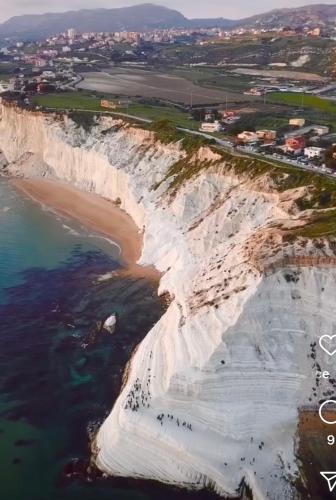 an aerial view of eroded cliffs next to the ocean at AMarescaladeiturchy Scaladeiturch in Realmonte
