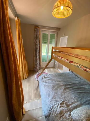 a bedroom with a bed and a chandelier at Villa Rosemarie in Valdeblore