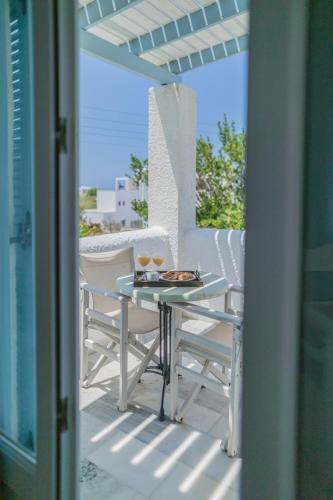 a white table and chairs on a patio at Agia Anna Living in Agia Anna Naxos