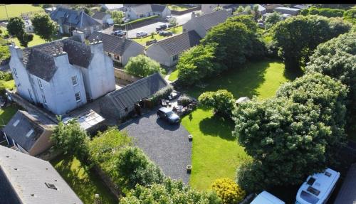 an aerial view of a large house with a yard at The Old Manse B&B in Thurso