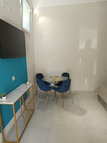 a room with two chairs and a table and a tv at Historic House in Ercolano