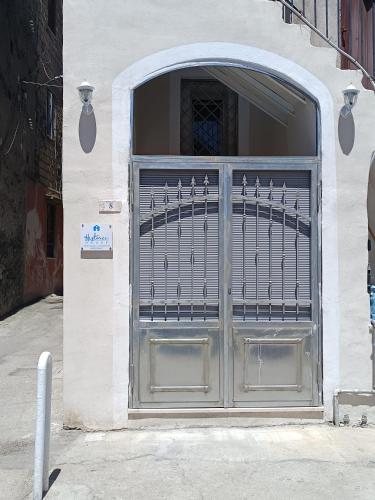a garage door with a metal gate on a building at Historic House in Ercolano