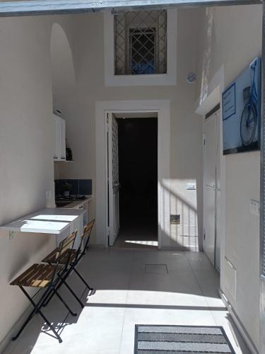 a kitchen with chairs and a table in a room at Historic House in Ercolano