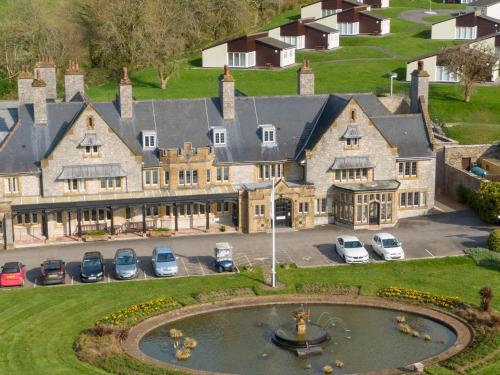 an aerial view of a large house with a fountain at Harcombe House Bungalow 8 in Newton Abbot