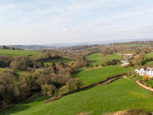an aerial view of green fields and houses at Harcombe House Bungalow 8 in Newton Abbot