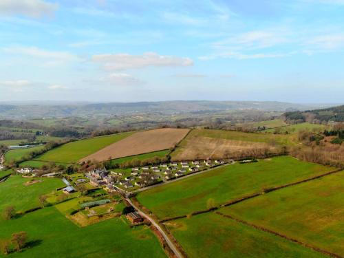 an aerial view of a field with houses and trees at Harcombe House Bungalow 8 in Newton Abbot