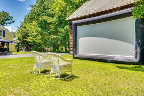 two chairs sitting in the grass next to a large garage at 6 Mi to Lake George Adirondack Home with Game Room in Warrensburg