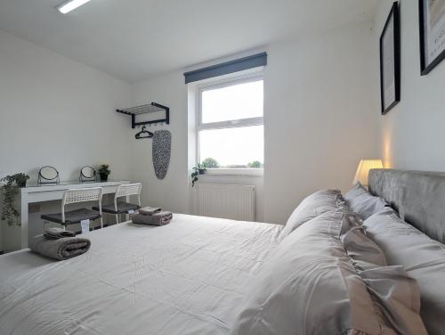 a white bedroom with a large bed and a window at Room Near City Centre Private Bath Free Parking in Liverpool