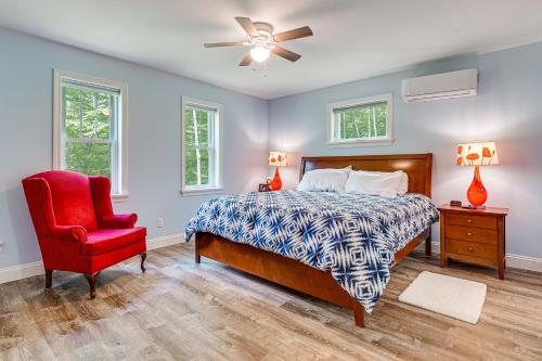 a bedroom with a bed and a red chair at Near Hiking Trails and Ski Resorts Killington Home! in Killington