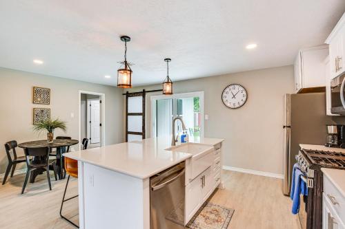 a kitchen with a table and a clock on the wall at Walk to Lewisville Lake Dog-Friendly Texas Home in Little Elm