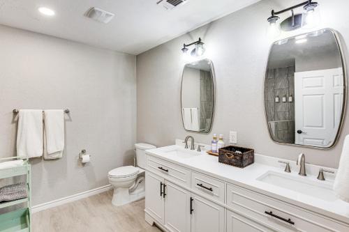 a bathroom with a sink and a toilet and a mirror at Walk to Lewisville Lake Dog-Friendly Texas Home in Little Elm
