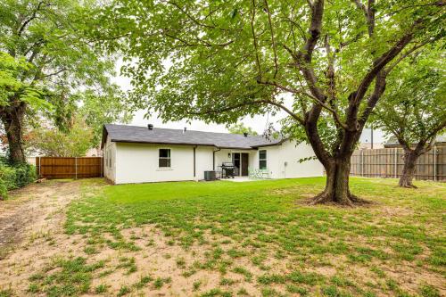a white house with a tree in a yard at Walk to Lewisville Lake Dog-Friendly Texas Home in Little Elm