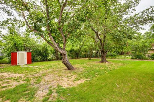 a tree and a red shed in a park at Walk to Lewisville Lake Dog-Friendly Texas Home in Little Elm