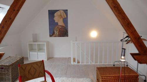a room with a painting of a woman on the wall at Ferienwohnung Wolfshagen in Wolfshagen